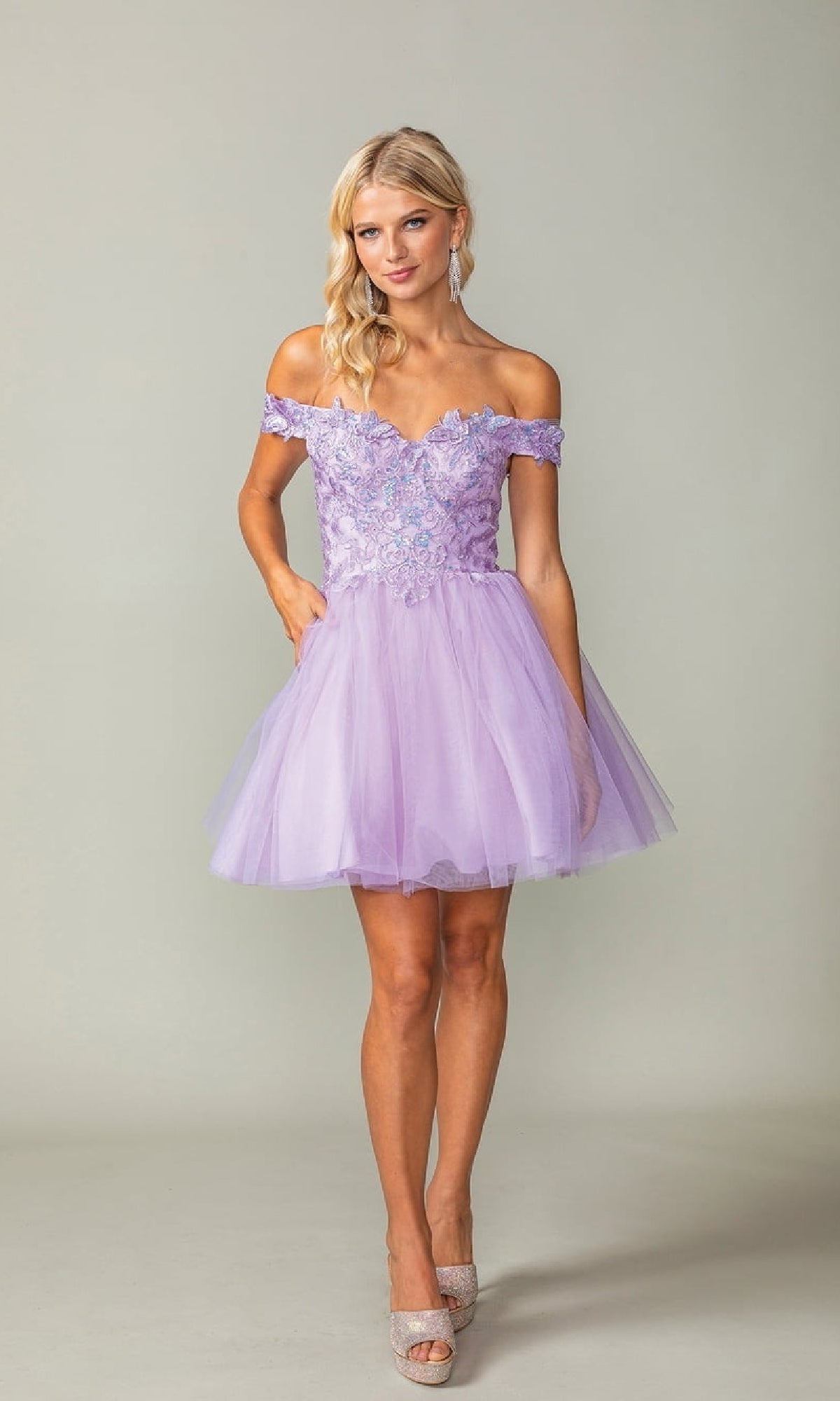 Woman wearing a lilac purple short off-shoulder dress against a plain background